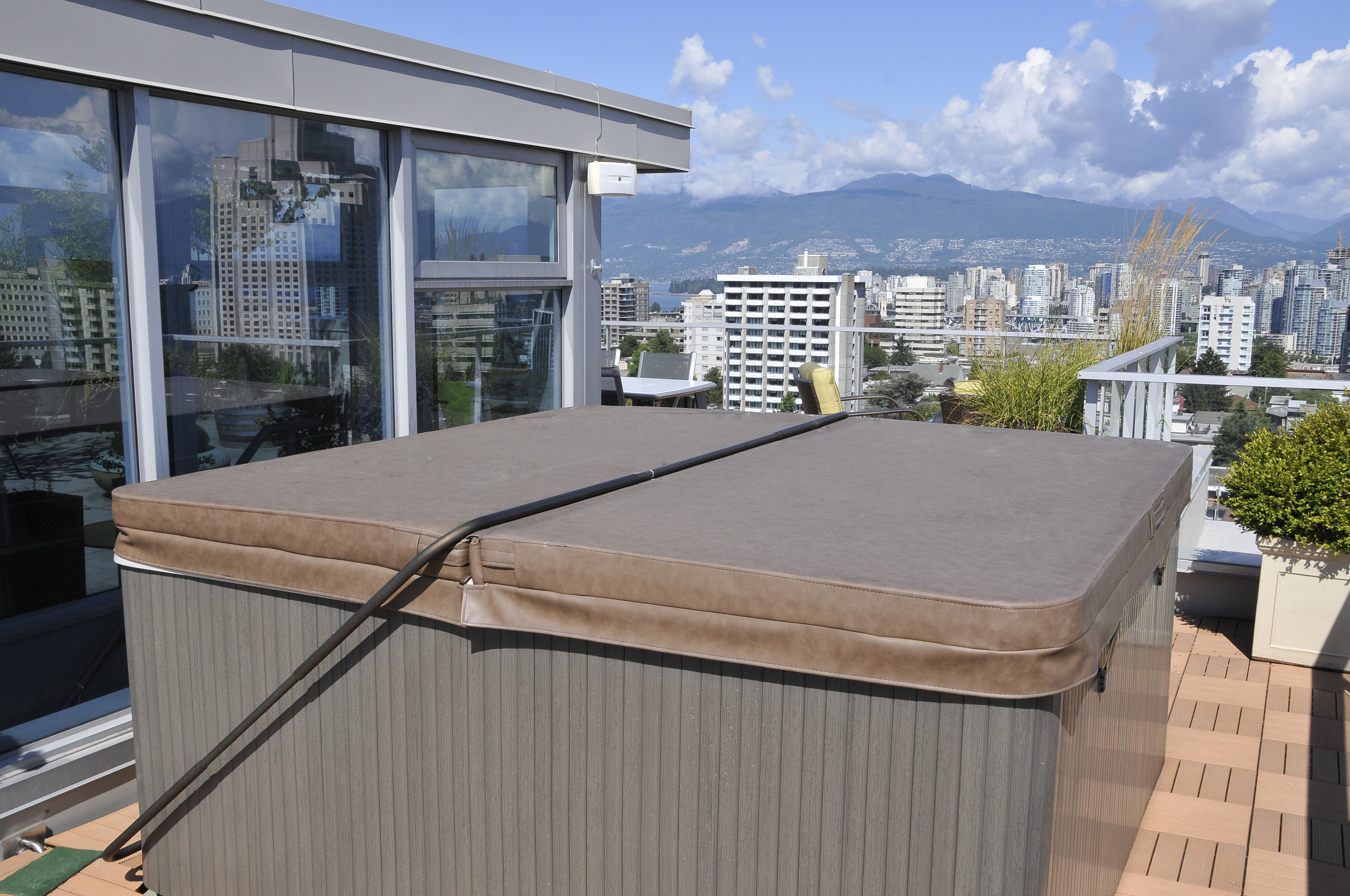 hot tub on rooftop patio overlooking city